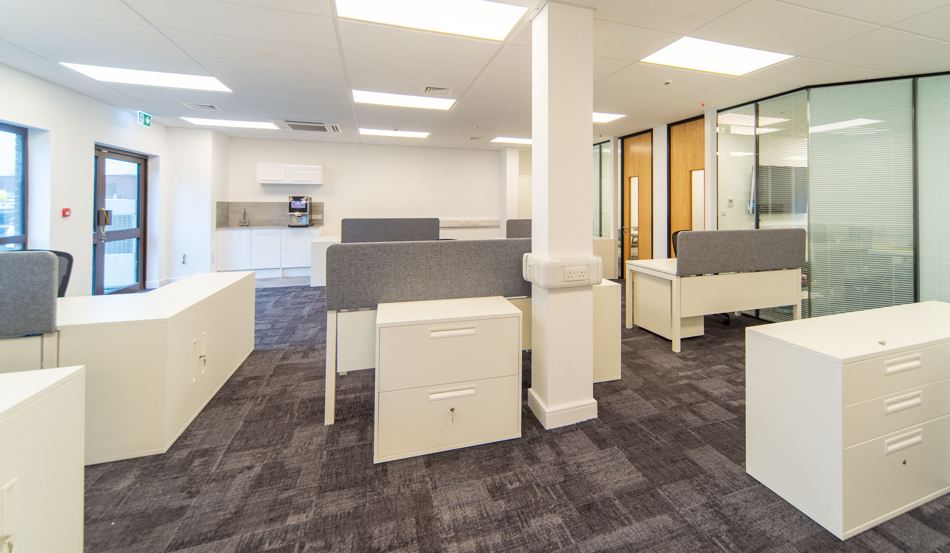 Office with Patterned Carpet, Tables, Chairs and Storage Cabinets